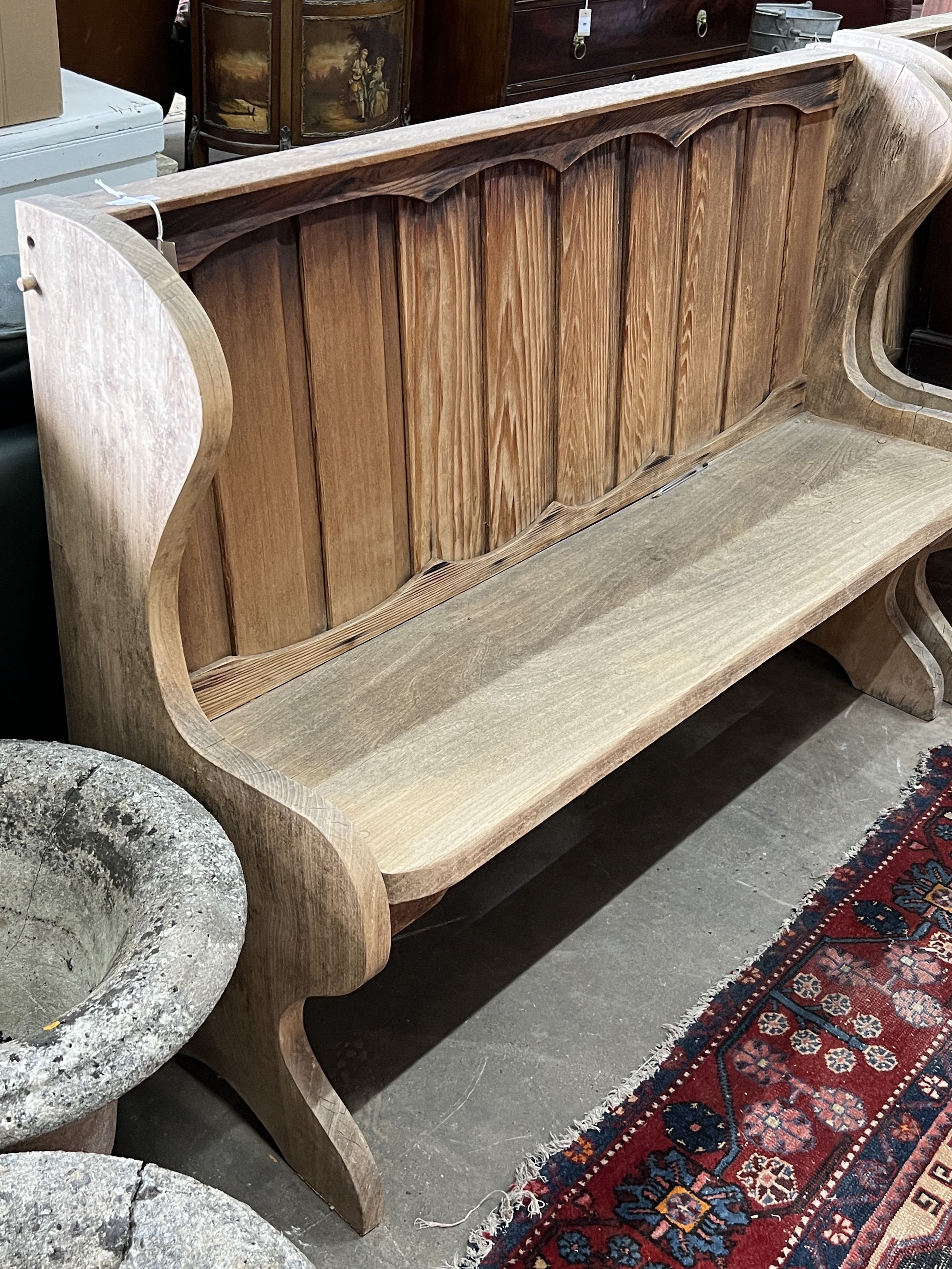 A pair of bleached oak pews, length 134cm, depth 45cm, height 98cm